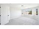 Bright bedroom features plush carpet, neutral paint, and natural light from two windows at 5352 Brookside Dr, Broomfield, CO 80020