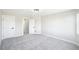 Spacious bedroom features neutral paint, plush carpet, and access to a bathroom and closet at 5352 Brookside Dr, Broomfield, CO 80020