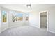 Well-lit bedroom with ample windows, neutral paint and plush carpeting, next to a walk-in closet at 5352 Brookside Dr, Broomfield, CO 80020