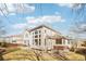Back of home with many large windows showing natural light and well-kept lawn at 5352 Brookside Dr, Broomfield, CO 80020