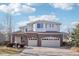 Charming two-story home with a brick facade and three-car garage at 5352 Brookside Dr, Broomfield, CO 80020