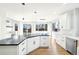 Open kitchen with black countertop island, modern appliances, and abundant natural light at 5352 Brookside Dr, Broomfield, CO 80020