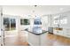 Bright kitchen features white cabinets, an island, marble backsplash, and stainless steel appliances at 5352 Brookside Dr, Broomfield, CO 80020