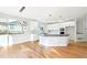 Open kitchen boasts a large island with black countertop and bright cabinetry at 5352 Brookside Dr, Broomfield, CO 80020