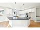 Bright modern kitchen with island, marble countertops, stainless steel appliances, and hardwood floors at 5352 Brookside Dr, Broomfield, CO 80020