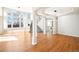Open-concept living room with hardwood floors and large windows at 5352 Brookside Dr, Broomfield, CO 80020