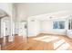 Spacious living room featuring hardwood floors, a modern light fixture, and plenty of natural light at 5352 Brookside Dr, Broomfield, CO 80020