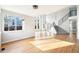 Open living room with hardwood floors, large windows, and a modern staircase at 5352 Brookside Dr, Broomfield, CO 80020