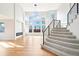 Staircase leading into a bright living room with hardwood floors and modern fireplace at 5352 Brookside Dr, Broomfield, CO 80020