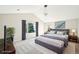 Staged main bedroom features a large bed, neutral paint, and natural light at 5352 Brookside Dr, Broomfield, CO 80020