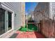 Cozy backyard with wood deck, artificial turf, and a stone chimney, perfect for outdoor relaxation at 11605 E Cornell Cir, Aurora, CO 80014