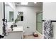 Bright bathroom features white walls, tile floor, and modern fixtures with tub/shower at 11605 E Cornell Cir, Aurora, CO 80014