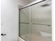 Bathroom features a sliding glass shower door with silver hardware and white tile at 11605 E Cornell Cir, Aurora, CO 80014