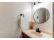 Bathroom features a granite countertop, modern faucet, and elegant round mirror at 11605 E Cornell Cir, Aurora, CO 80014