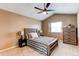 Bedroom features ceiling fan, neutral walls, carpeted floors, a window, and wooden furniture at 11605 E Cornell Cir, Aurora, CO 80014