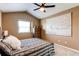 Bedroom featuring ceiling fan, neutral walls, carpeted floors, a window, and picture on wall at 11605 E Cornell Cir, Aurora, CO 80014