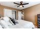 Bedroom with neutral walls, carpeted floors, closet, and en suite bathroom access at 11605 E Cornell Cir, Aurora, CO 80014