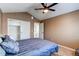 Bedroom with neutral walls, carpeted floors, closet, and en suite bathroom access at 11605 E Cornell Cir, Aurora, CO 80014
