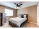 Bedroom featuring ceiling fan, neutral walls, carpeted floors, a window, and wooden dresser at 11605 E Cornell Cir, Aurora, CO 80014