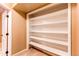 Walk-in closet features built-in shelving for optimal organization and storage at 11605 E Cornell Cir, Aurora, CO 80014