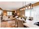 Open-concept dining area with a white table, stylish lighting, and a view of the living room for seamless entertaining at 11605 E Cornell Cir, Aurora, CO 80014