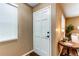 Entryway features a white front door, hardwood floors, side table, and window at 11605 E Cornell Cir, Aurora, CO 80014