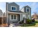 Charming two-story home with light grey siding, a stone chimney, and a well-maintained front yard under a clear blue sky at 11605 E Cornell Cir, Aurora, CO 80014