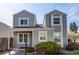 Charming two-story home with a covered porch, gray siding and updated windows at 11605 E Cornell Cir, Aurora, CO 80014