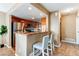 Modern kitchen with a breakfast bar, granite countertops, stainless steel appliances, and ample cabinet space at 11605 E Cornell Cir, Aurora, CO 80014