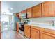 Kitchen with wood cabinets, stainless steel appliances, stone countertops, and view to dining area at 11605 E Cornell Cir, Aurora, CO 80014