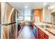 Well-equipped kitchen with stainless steel appliances, wooden cabinets, ample counter space, and a dining area for casual meals at 11605 E Cornell Cir, Aurora, CO 80014
