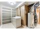 Laundry room with washer, dryer, and shelving at 11605 E Cornell Cir, Aurora, CO 80014