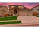 Charming two-story home with a stone facade, well-manicured lawn, and a spacious two car garage at 80 Back Nine Dr, Castle Pines, CO 80108
