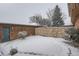 Private backyard with stone wall and snow covered ground at 12136 E 2Nd Dr, Aurora, CO 80011