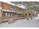 Snow covered exterior view of townhome with deck at 12136 E 2Nd Dr, Aurora, CO 80011