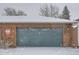 Attached garage with wood exterior and teal garage door at 12136 E 2Nd Dr, Aurora, CO 80011