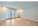 Living room with wood-look floors and sliding glass doors to patio at 12136 E 2Nd Dr, Aurora, CO 80011