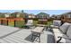 Relaxing backyard deck with seating area and view of homes at 6112 Black Mesa Rd, Frederick, CO 80516