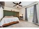 Cozy bedroom with a bed, nightstand, and green accent wall at 6112 Black Mesa Rd, Frederick, CO 80516