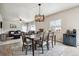 Bright dining room with a rustic wooden table and chandelier at 6112 Black Mesa Rd, Frederick, CO 80516