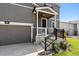 Two-story house with gray siding, a white porch, and a two-car garage at 6112 Black Mesa Rd, Frederick, CO 80516