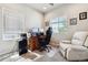 Bright home office featuring a desk, chair, and recliner at 6112 Black Mesa Rd, Frederick, CO 80516