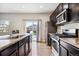 Modern kitchen with dark cabinets, stainless steel appliances, and an island at 6112 Black Mesa Rd, Frederick, CO 80516