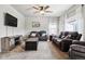 Relaxing living room with comfortable sofas, a large TV, and a ceiling fan at 6112 Black Mesa Rd, Frederick, CO 80516