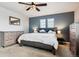 Main bedroom with a dresser and a king-size bed at 6112 Black Mesa Rd, Frederick, CO 80516