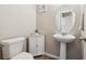 Clean powder room with pedestal sink and corner storage at 6112 Black Mesa Rd, Frederick, CO 80516