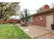 Landscaped backyard with patio, dining set, and well-maintained lawn at 6365 S Valleyview St, Littleton, CO 80120