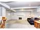 Finished basement featuring a cozy seating area with a decorative fireplace at 6365 S Valleyview St, Littleton, CO 80120