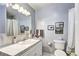 Cozy bathroom featuring a vanity with sink, framed mirror, toilet, and shower with curtain at 6365 S Valleyview St, Littleton, CO 80120