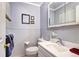 Classic bathroom with tiled walls, pedestal sink, toilet, and a framed mirror at 6365 S Valleyview St, Littleton, CO 80120